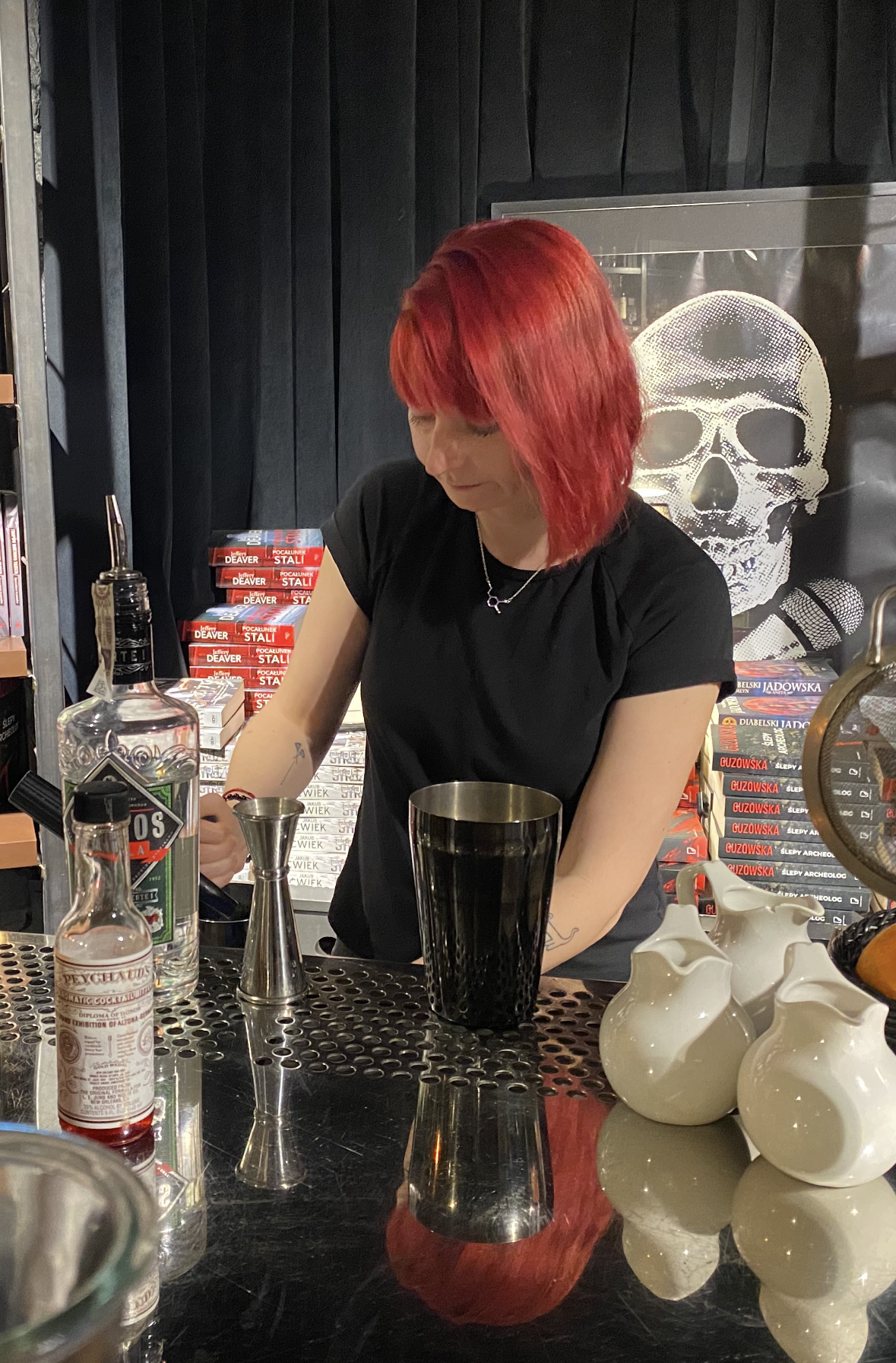 Kasia mixing a drink behind the bar