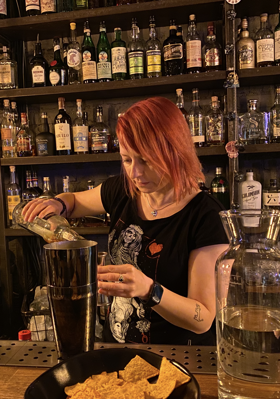 Kasia pouring a spirit into a shaker