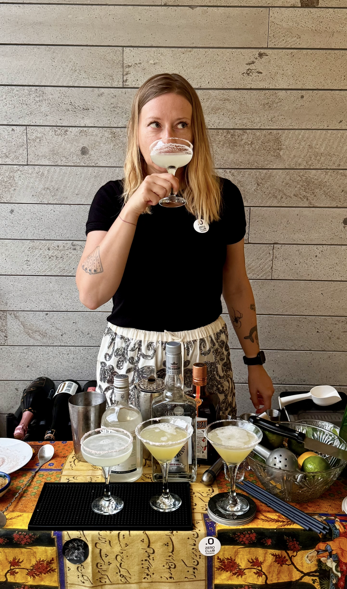 Katarzyna 'Kasia' Javaheri tasting a cocktail, wearing a Zero Club Madeira badge